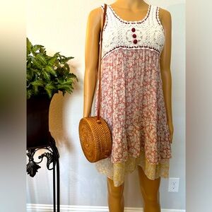 Sleeveless dress with crotched lined top with printed skirt. Size M